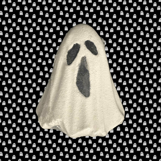 Ghost-shaped bath bomb on a black background with white ghost pattern