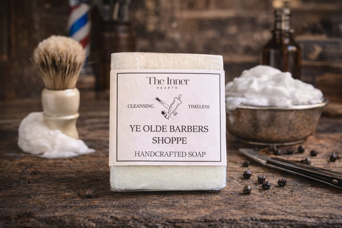 Handcrafted soap bar from Ye Olde Barbers Shoppe with shaving accessories in the background.