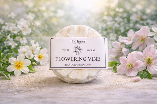 Handcrafted soap labeled 'Flowering Vine' with a floral background
