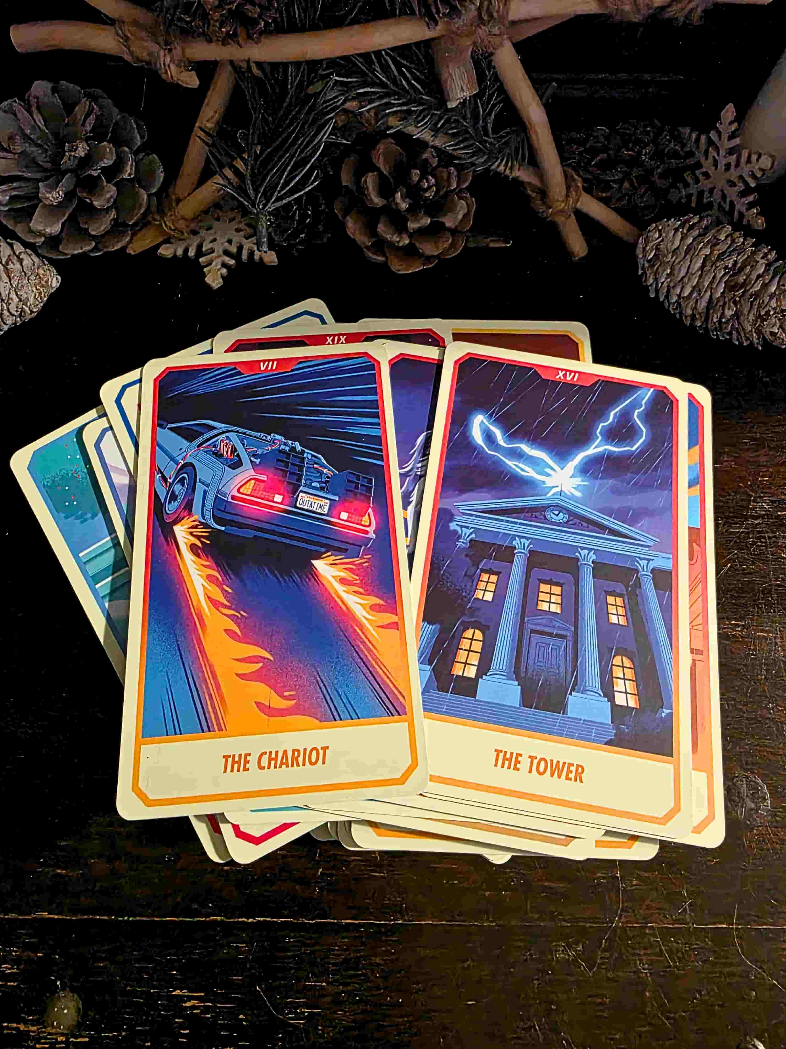 Two tarot cards titled 'The Chariot' and 'The Tower' on a dark surface with decorative elements.