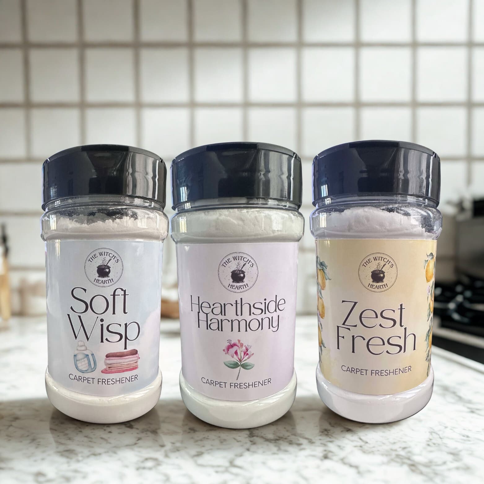 Three carpet freshener bottles labeled 'Soft Whisp', 'Hearthside Harmony', and 'Zest Fresh' on a kitchen counter.