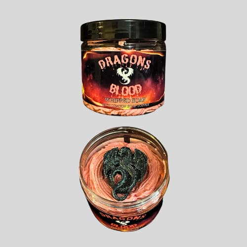 Two glass jars with 'Dragon's Blood' product on a gray background