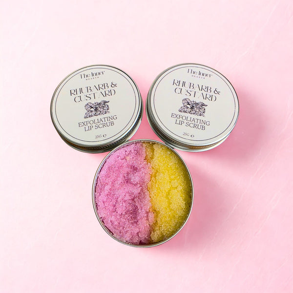 Rhubarb and custard lip scrub showing pink and yellow exfoliating sugar texture in a metal tin