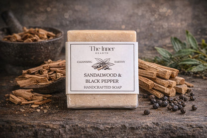 Handcrafted soap bar with sandalwood and black pepper scent on a rustic background