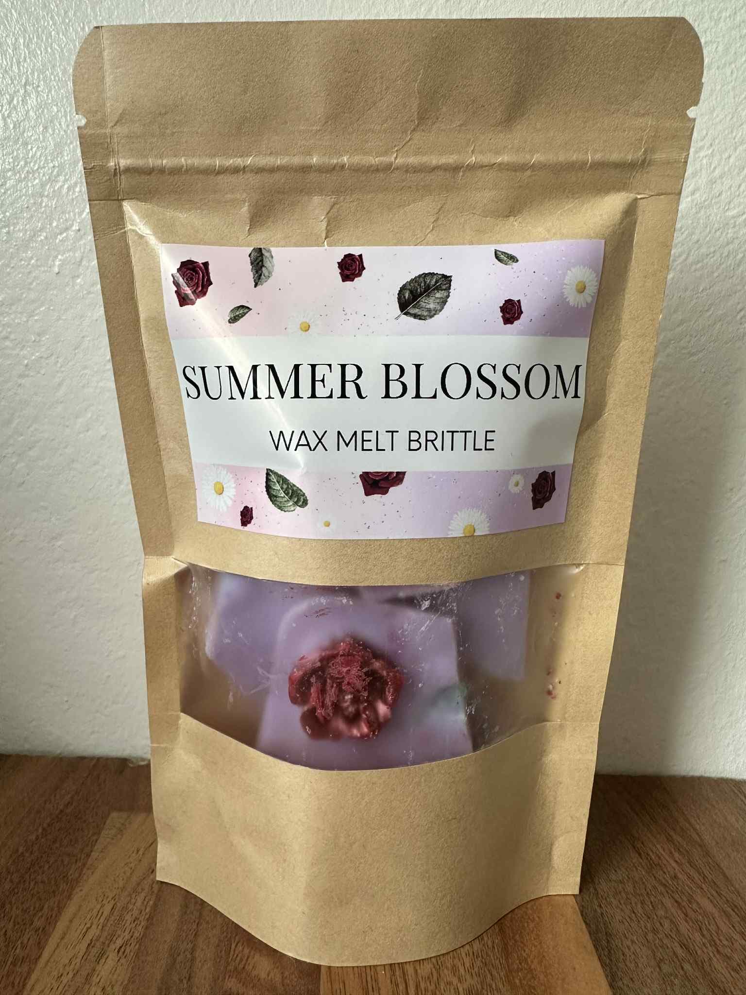 Wax melt brittle package labeled 'Summer Blossom' on a wooden surface.