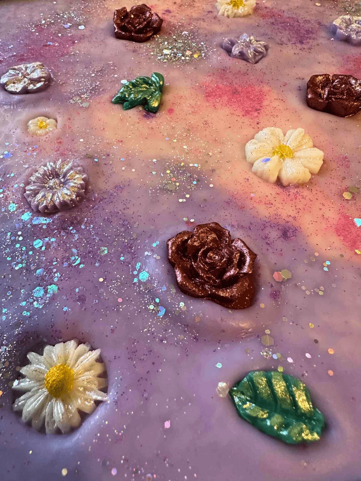 Colorful wax melt brittle including flowers and leaves