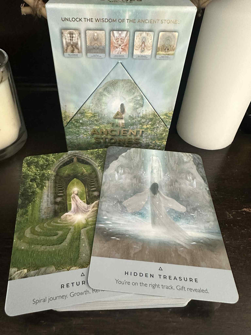 Set of tarot cards with nature-themed illustrations on a wooden surface.