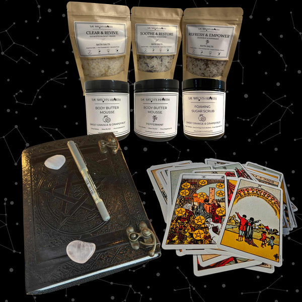 Collection of skincare products, tarot cards, and a journal on a starry background