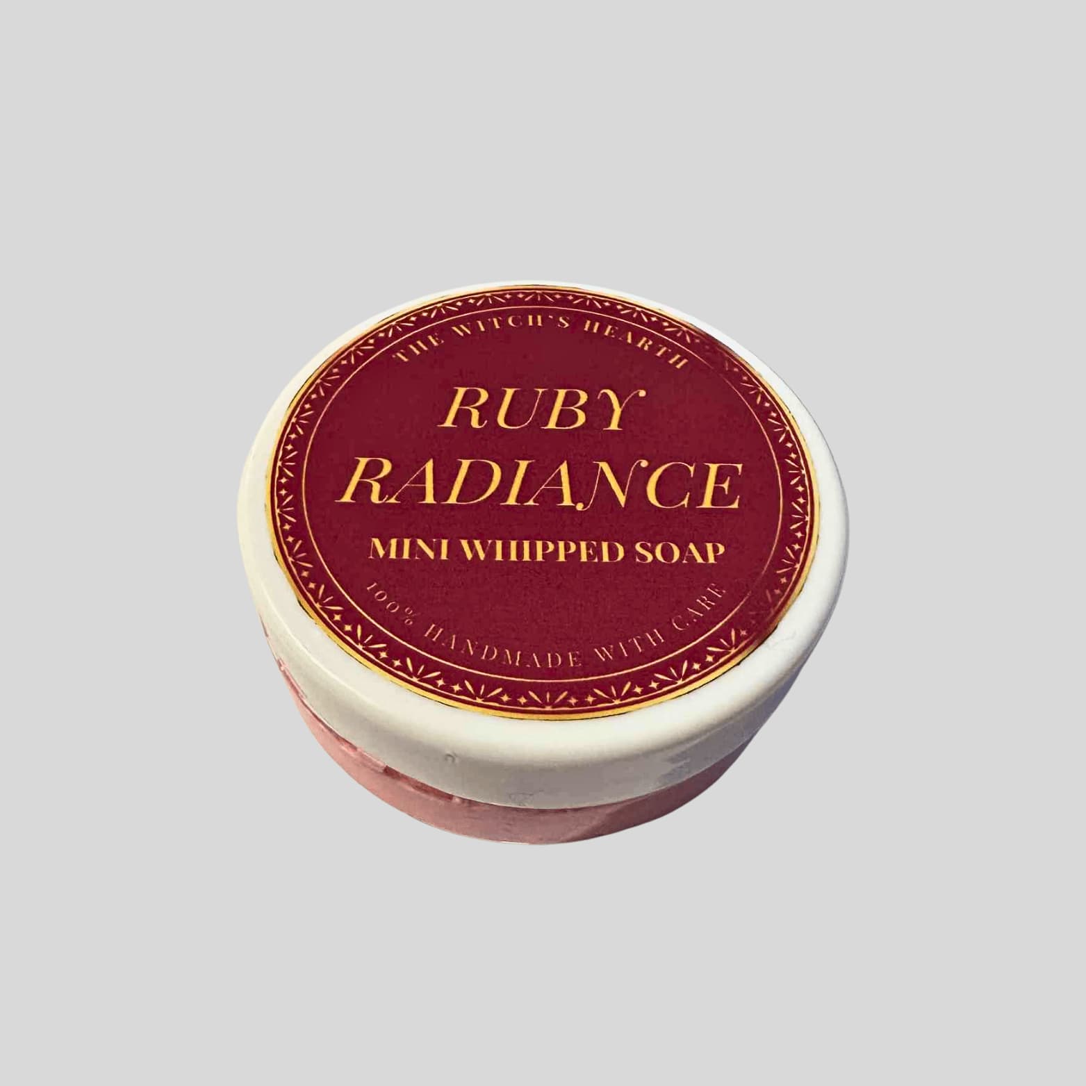 Ruby Radiance mini whipped soap in a round container with a red label on a light gray background